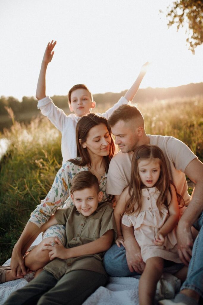 pexels-photo-19510840-19510840 A family enjoying a sunny outdoor picnic together in a field.
